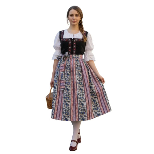 Black dirndl with floral apron worn by a model, showcasing traditional Bavarian folk dress style.